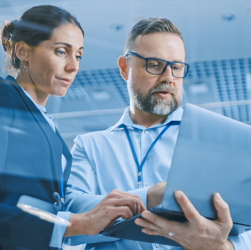 wotech-above-us-man-and-woman-look-at-laptop